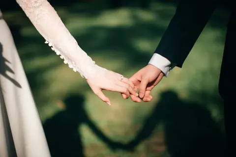 A couple holding hands (illustrative image)